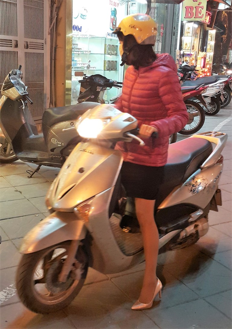 Mulher de salto alto piltotando scooter no Vietnã @pratserie